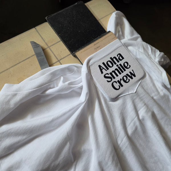 Aloha Smile Crew pocket print on a white shirt at RVA Threads screen printing, Virginia