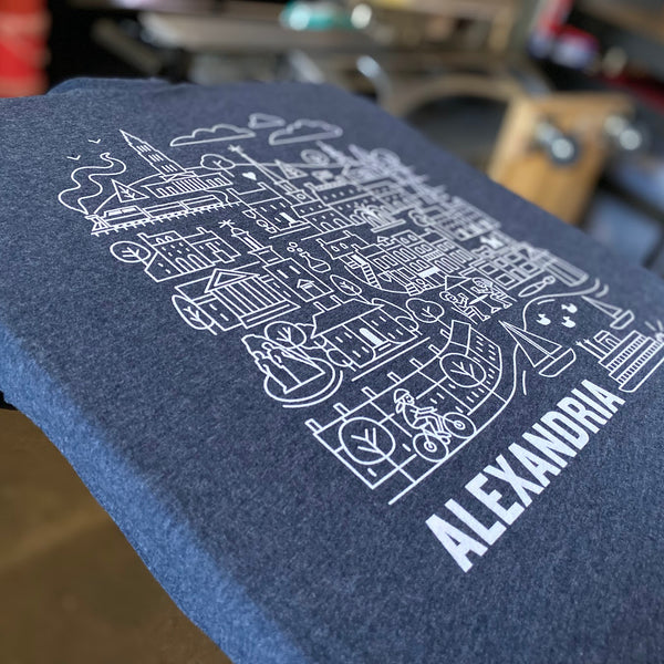Alexandria city illustration in white ink on a Midnight Navy Next Level 6210 tee at RVA Threads screen printing, Virginia