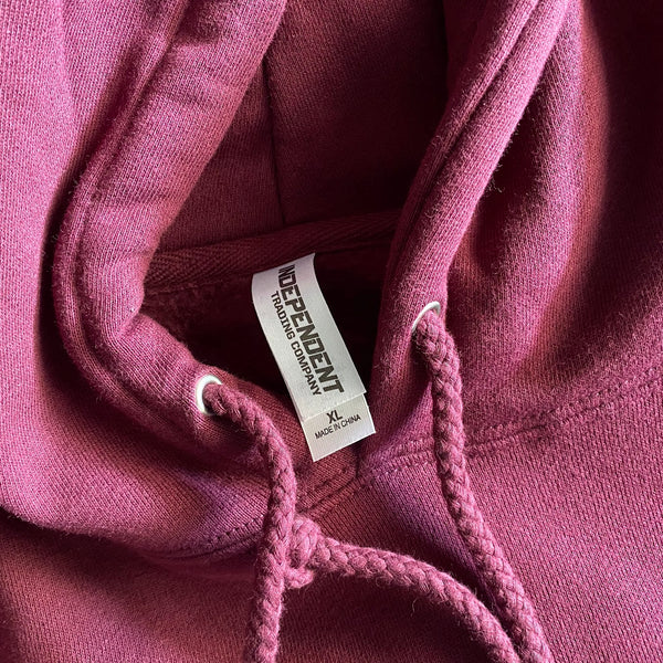 Blank maroon Independent Trading Co. hoodie with the hood and drawstrings close up at RVA Threads screen printing, Virginia