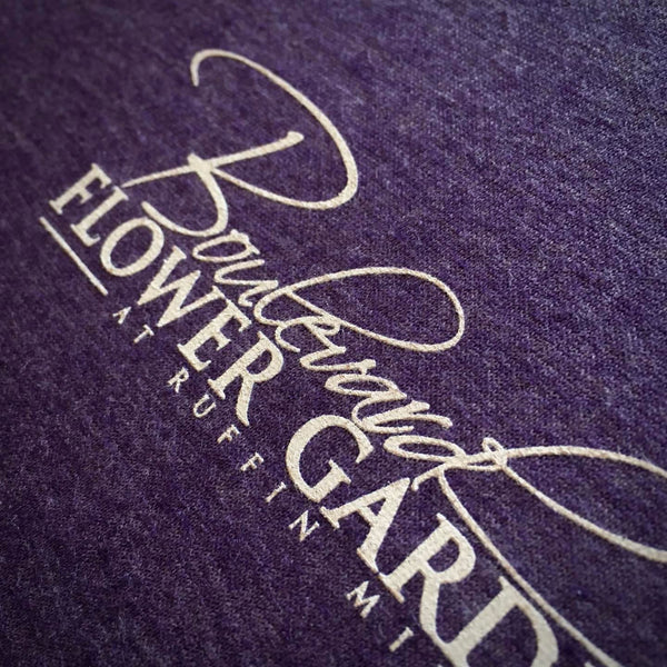 Boulevard Flower Gardens script logo in cream ink on a purple heather tee at RVA Threads screen printing, Virginia
