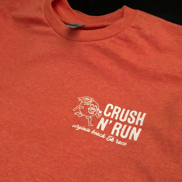 Crush N' Run left chest logo in white ink on an orange tee, close up at RVA Threads screen printing, Virginia