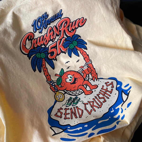 10th Annual Crush Run 5K Send Crushes design in red, blue and green on a butter tee, laid flat at RVA Threads screen printing, Virginia