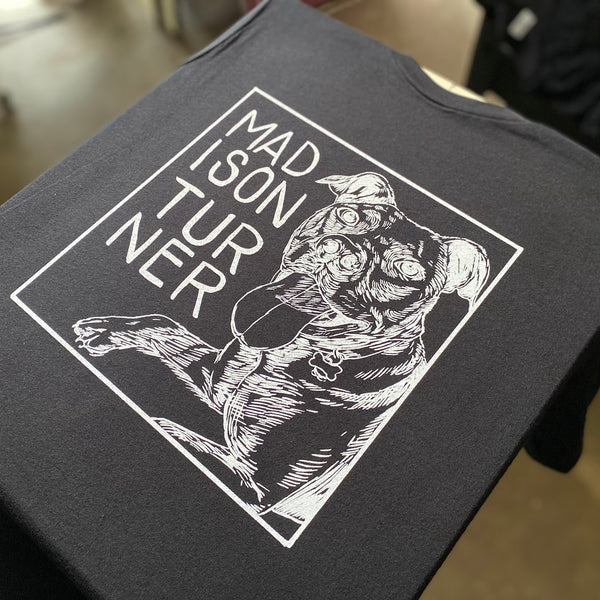 Dog portrait design in white ink on a black tee laid on the press at RVA Threads screen printing, Virginia