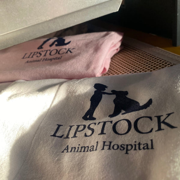 Lipstock Animal Hospital logo in navy ink on white and pink sweatshirts at RVA Threads screen printing, Virginia