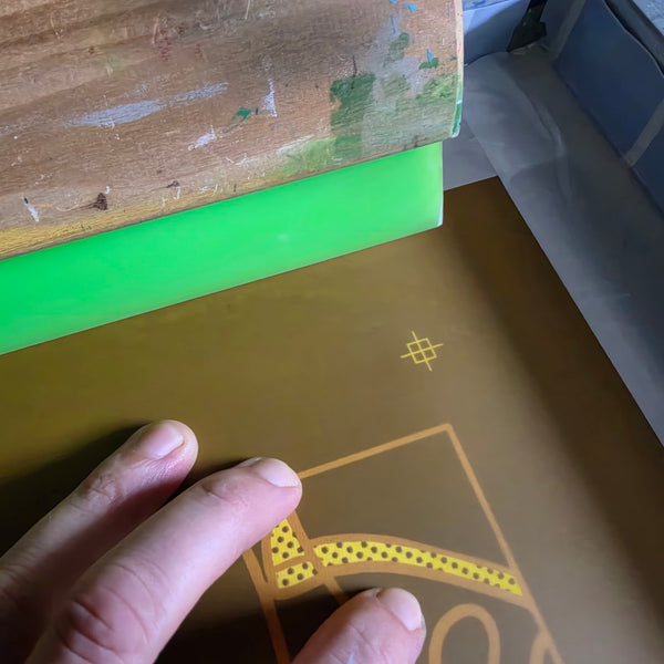 Burned Meow Royale DJ Rabbit screen with halftone dots and a registration mark beside a green squeegee at RVA Threads screen printing, Virginia
