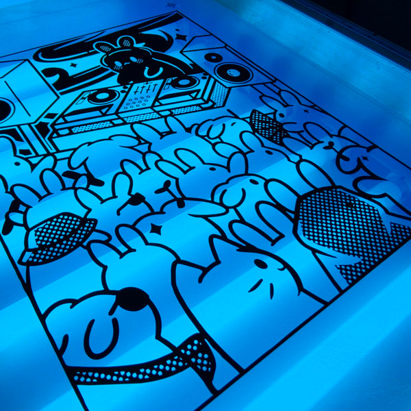 Meow Royale DJ Rabbit film positive laid on the exposure unit glass under the blue light at RVA Threads screen printing, Virginia