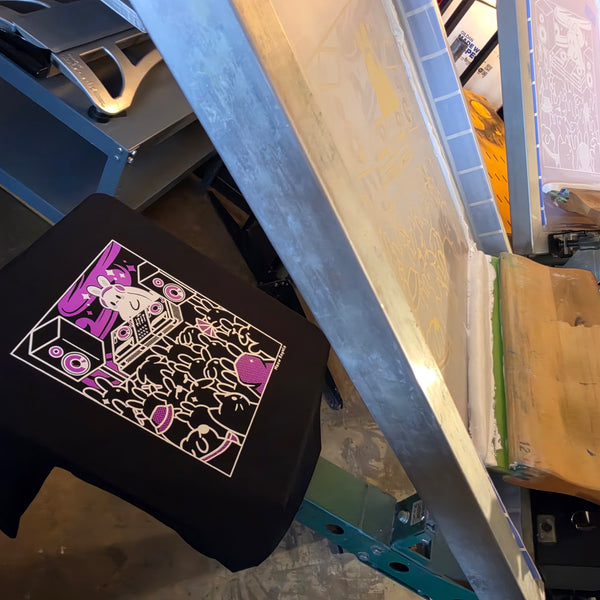 Meow Royale DJ Rabbit print in white and purple ink on a black Gildan 2000 tee with the screen lifted at RVA Threads screen printing, Virginia