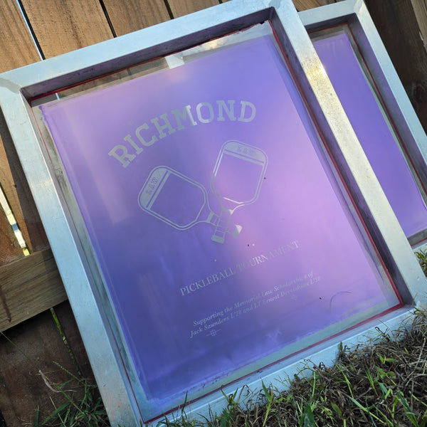 Two exposed screens with the Richmond Law Pickleball Tournament design, drying in the sun at RVA Threads screen printing, Virginia