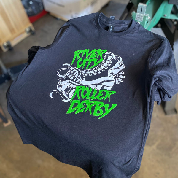 River City Roller Derby design in green and white ink on a navy tee at RVA Threads screen printing, Virginia