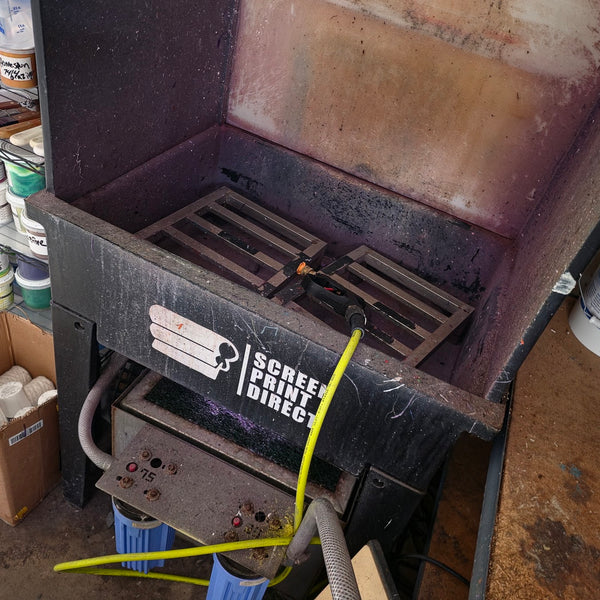 Screen Print Direct washout booth with the pressure washer line next to the plastisol ink shelves at RVA Threads screen printing, Virginia