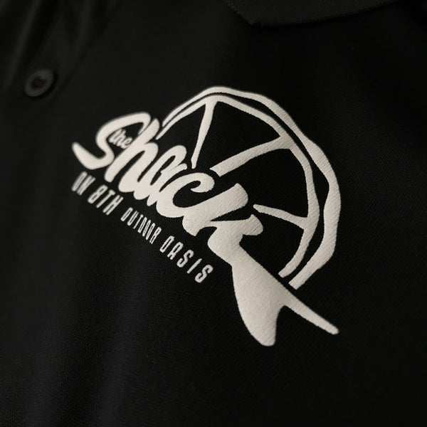The Shack hat logo in white ink on a black tee, close up of the print at RVA Threads screen printing, Virginia