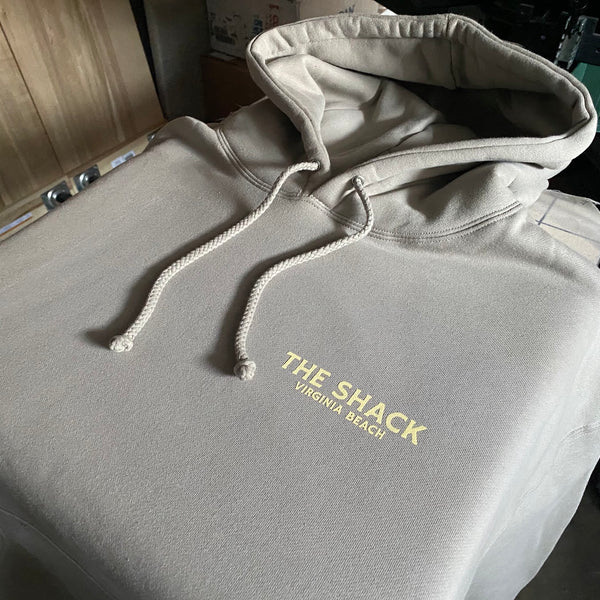 The Shack left chest logo in gold ink on a cream pullover hoodie at RVA Threads screen printing, Virginia