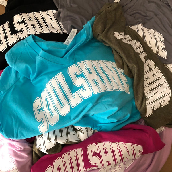 Soulshine arch lettering tees in teal, pink and gray, piled after printing at RVA Threads screen printing, Virginia