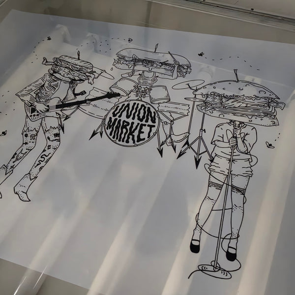 Union Market sandwich band film positive lit up on the exposure unit at RVA Threads screen printing, Virginia