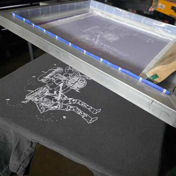 Union Market sandwich band print in white ink on a Pepper Comfort Colors 1717 tee with the screen lifted at RVA Threads screen printing, Virginia