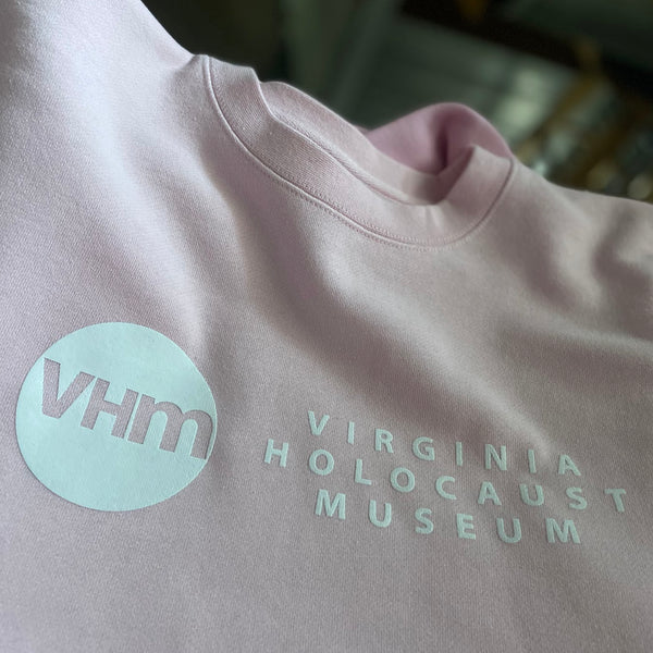 Virginia Holocaust Museum VHM logo in mint and white ink on a light pink tee at RVA Threads screen printing, Virginia