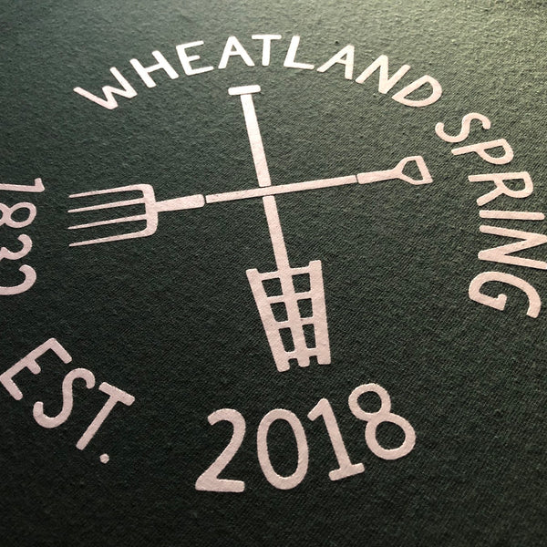 Wheatland Spring Est. 2018 logo in white ink on a dark green tee at RVA Threads screen printing, Virginia