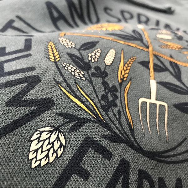 Wheatland Spring wheat and pitchfork farm design on a gray tee, close up at RVA Threads screen printing, Virginia