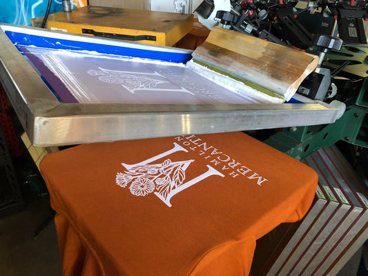 Bella Canvas sweatshirt screen printed for The Mercantile, on-press photo.