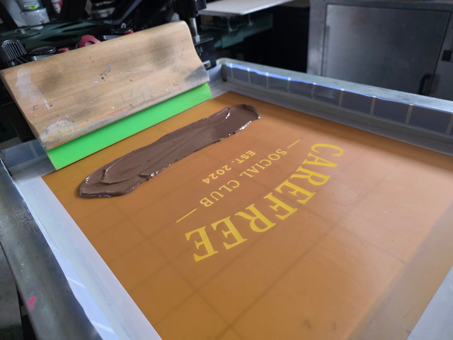 Carefree Social Club screen with brown ink and squeegee at RVA Threads screen printing, Virginia