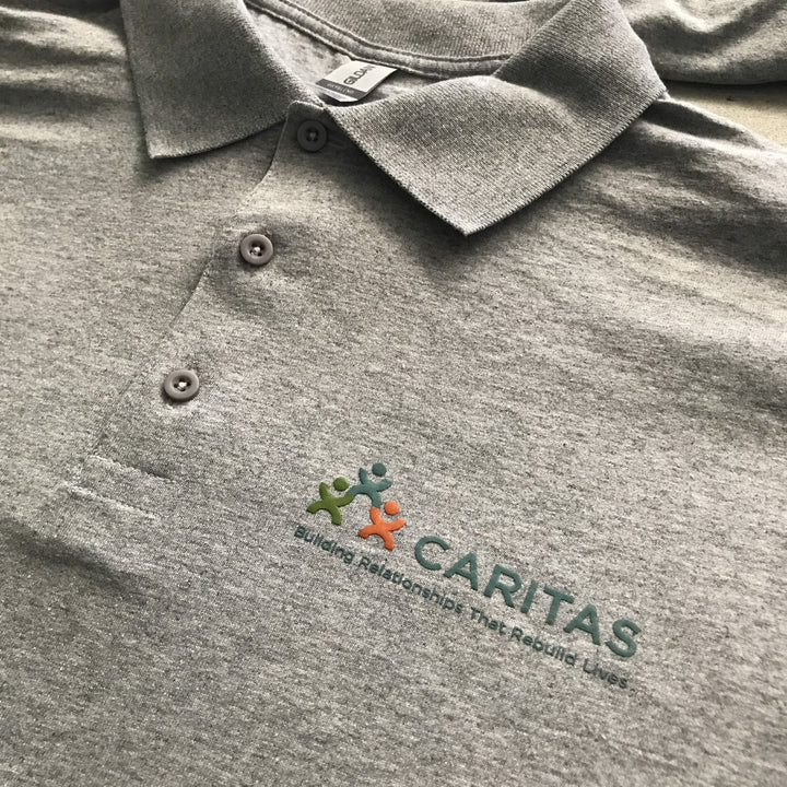 Finished Caritas polo left chest print, screen printed by RVA Threads