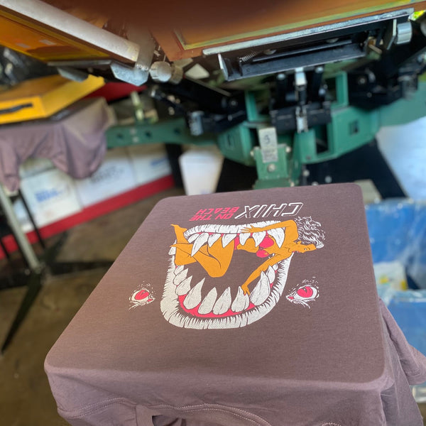 Chix graphic print on a shirt on the press at RVA Threads screen printing, Virginia