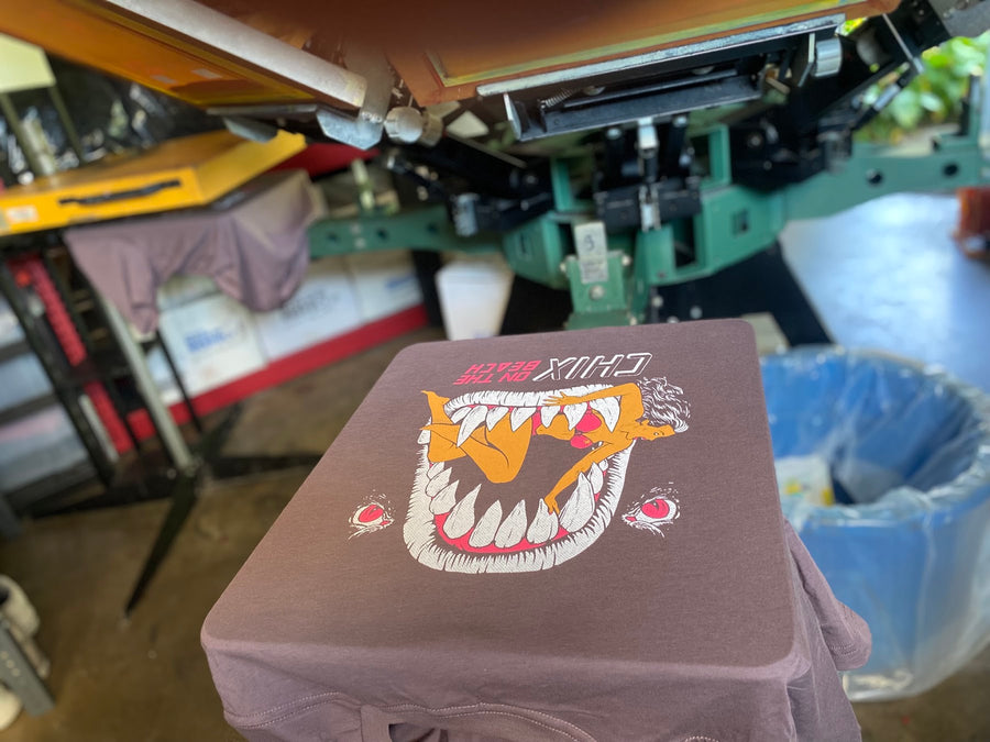 Chix graphic print on a shirt on the press at RVA Threads screen printing, Virginia