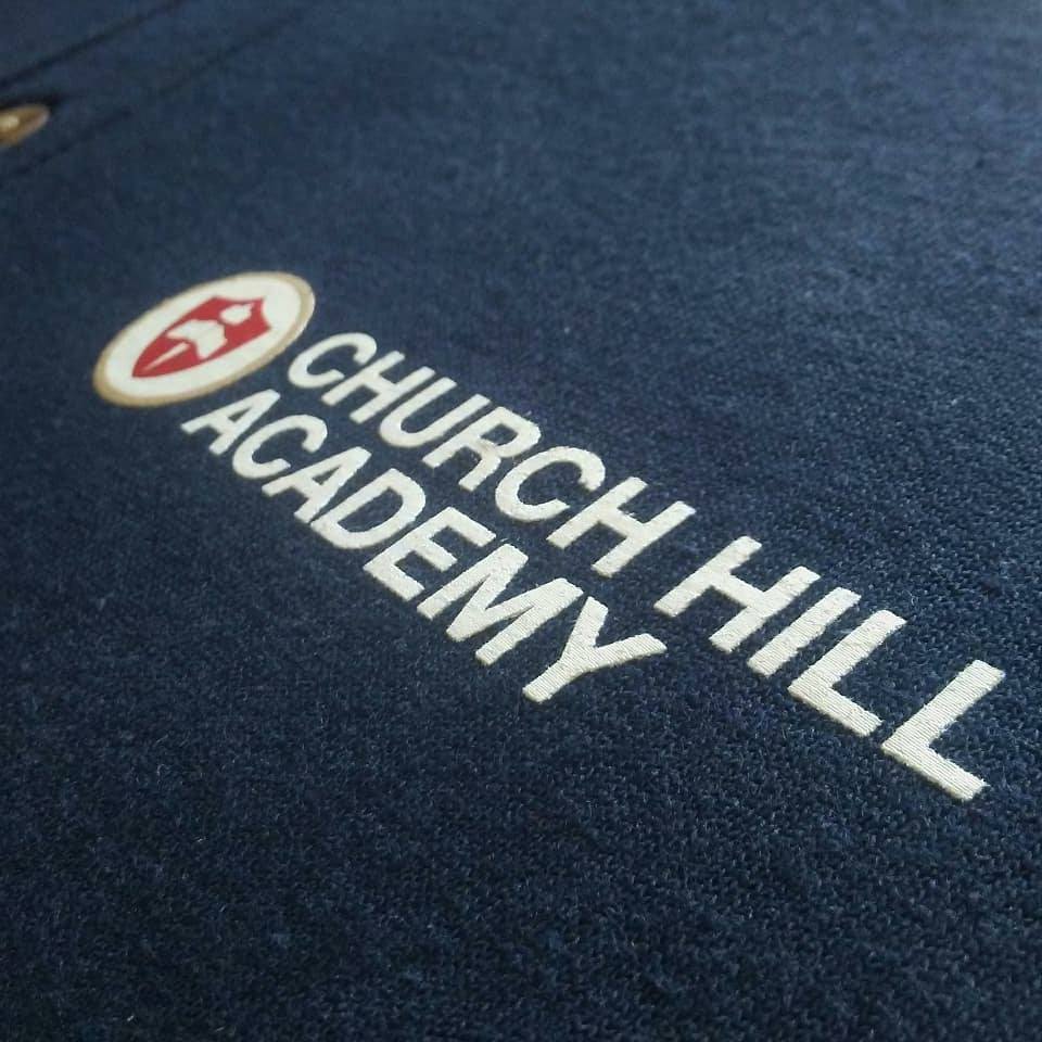 Custom screen printed polo shirts for Church Hill Academy in Richmond, Virginia. 