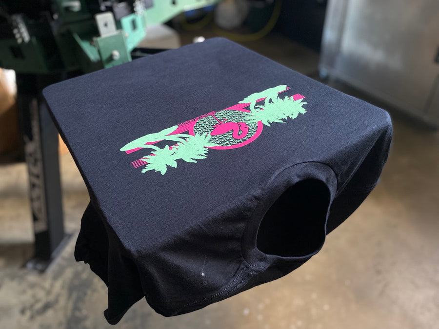 Multi-color pink and green print on a black shirt at RVA Threads screen printing, Virginia