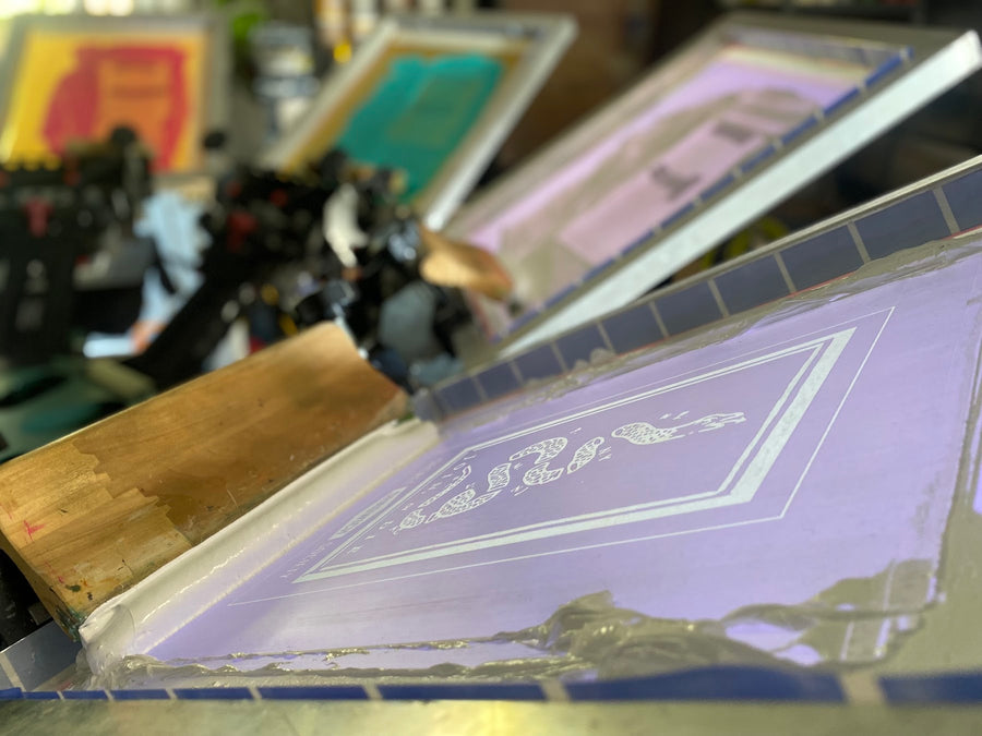Screens lined up on the press for a multi-color job at RVA Threads screen printing, Virginia