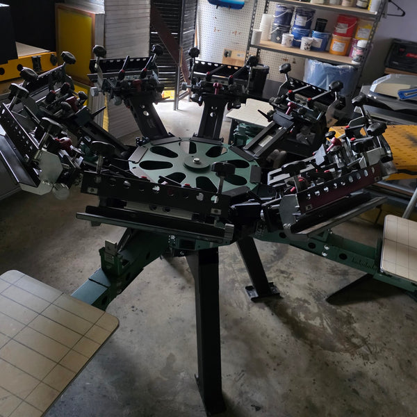 Six-color screen printing press loaded and ready at RVA Threads screen printing, Virginia