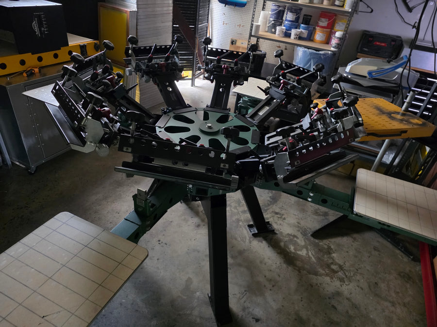 Six-color screen printing press loaded and ready at RVA Threads screen printing, Virginia