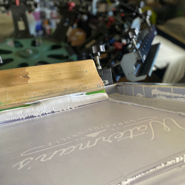 Waterman's screen with white ink and squeegee at RVA Threads screen printing, Virginia