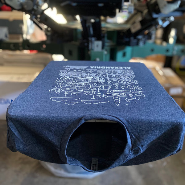 Alexandria city illustration in white ink on a Midnight Navy Next Level 6210 tee on the press pallet at RVA Threads screen printing, Virginia