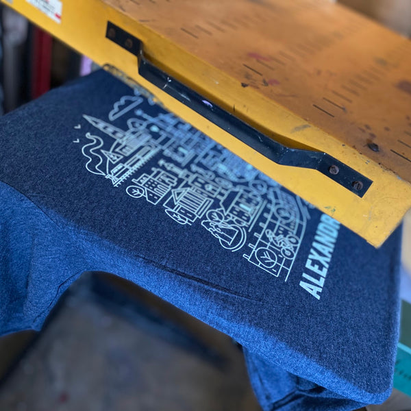 Alexandria design in white ink on a Midnight Navy Next Level 6210 tee under the flash dryer at RVA Threads screen printing, Virginia
