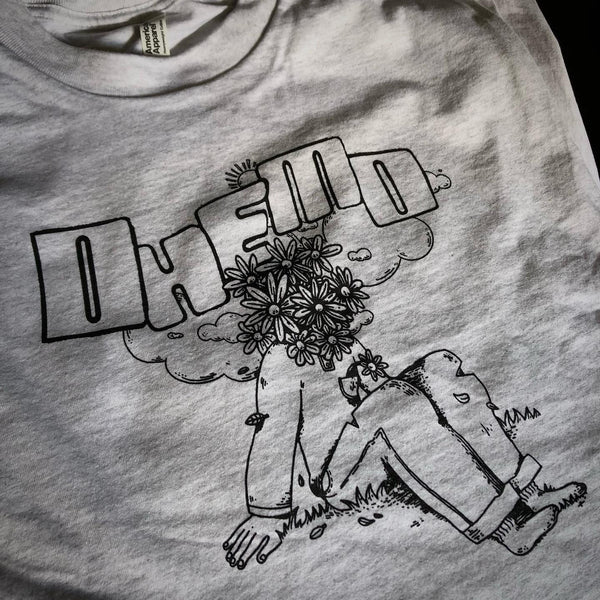 Black ink illustration of a figure with a flower head on a heather gray tee at RVA Threads screen printing, Virginia