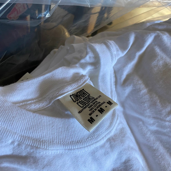 Blank white tee collar and size tag close up before printing at RVA Threads screen printing, Virginia