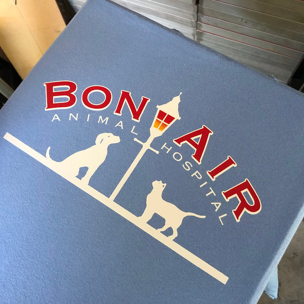 Bon Air Animal Hospital logo in red and white ink on a blue tee at RVA Threads screen printing, Virginia