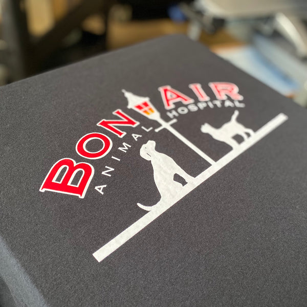 Bon Air Animal Hospital logo in red and white ink on a charcoal tee at RVA Threads screen printing, Virginia