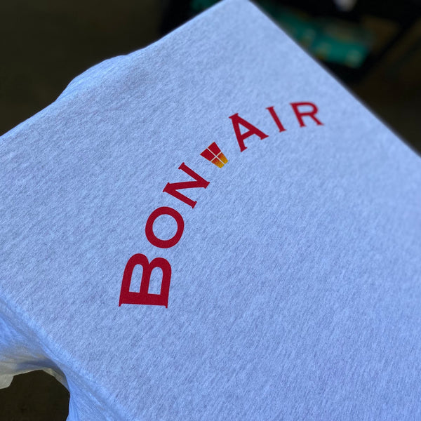 Bon Air lettering in red ink on a white tee on the press pallet at RVA Threads screen printing, Virginia