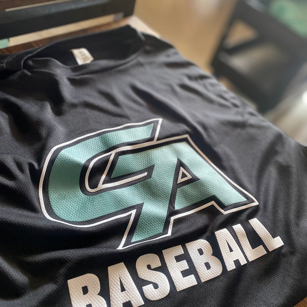 CA Baseball logo in white and teal ink on a black tee, laid flat at RVA Threads screen printing, Virginia
