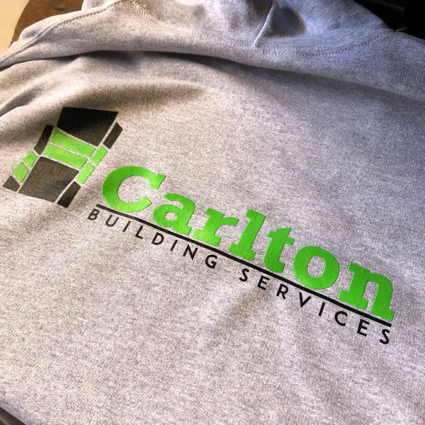 Carlton Building Services logo in green and black ink on a gray sweatshirt at RVA Threads screen printing, Virginia