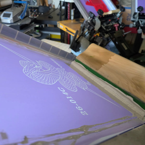 Cobras design screen flooded with white ink on the press, ready for the black crewnecks at RVA Threads screen printing, Virginia
