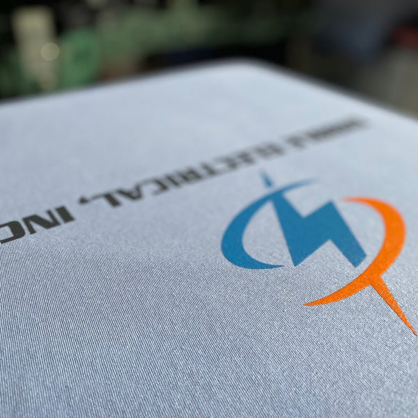 Dibble Electrical, Inc. logo on a gray tee on the press pallet, close up at RVA Threads screen printing, Virginia