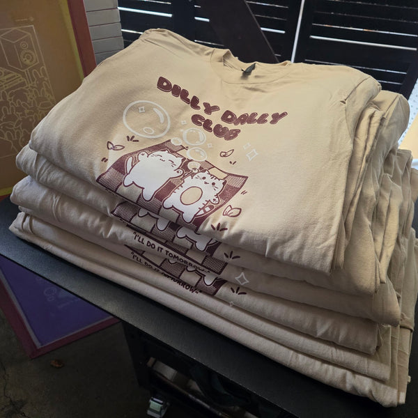 Dilly Dally Club print in maroon and white on Sand Gildan 2000 tees, folded and stacked at RVA Threads screen printing, Virginia