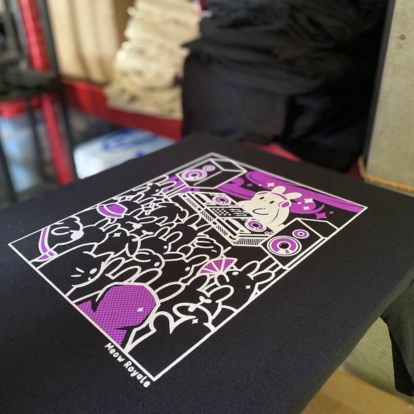 DJ bunny design in purple and white ink on a black tee on the press pallet at RVA Threads screen printing, Virginia