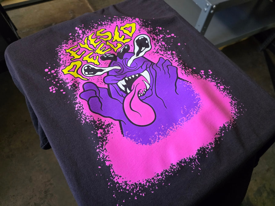 Eyes Peeled print in pink, purple, yellow and white ink on a Black Comfort Colors 1717 tee at RVA Threads screen printing, Virginia