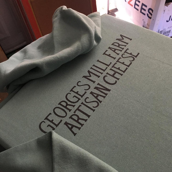 George's Mill Farm Artisan Cheese logo in black ink on a gray hoodie at RVA Threads screen printing, Virginia