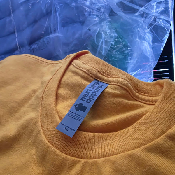 Blank gold Next Level 3600 tee for the George's Mill Farm Goat-Topia order, fresh out of the bag at RVA Threads screen printing, Virginia