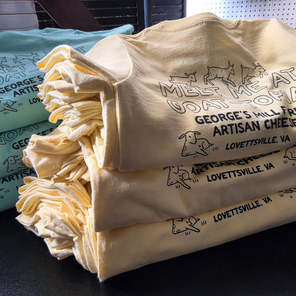 George's Mill Farm Meet Me at Goat-Topia shirts in yellow and mint, black ink, folded and stacked at RVA Threads screen printing, Virginia